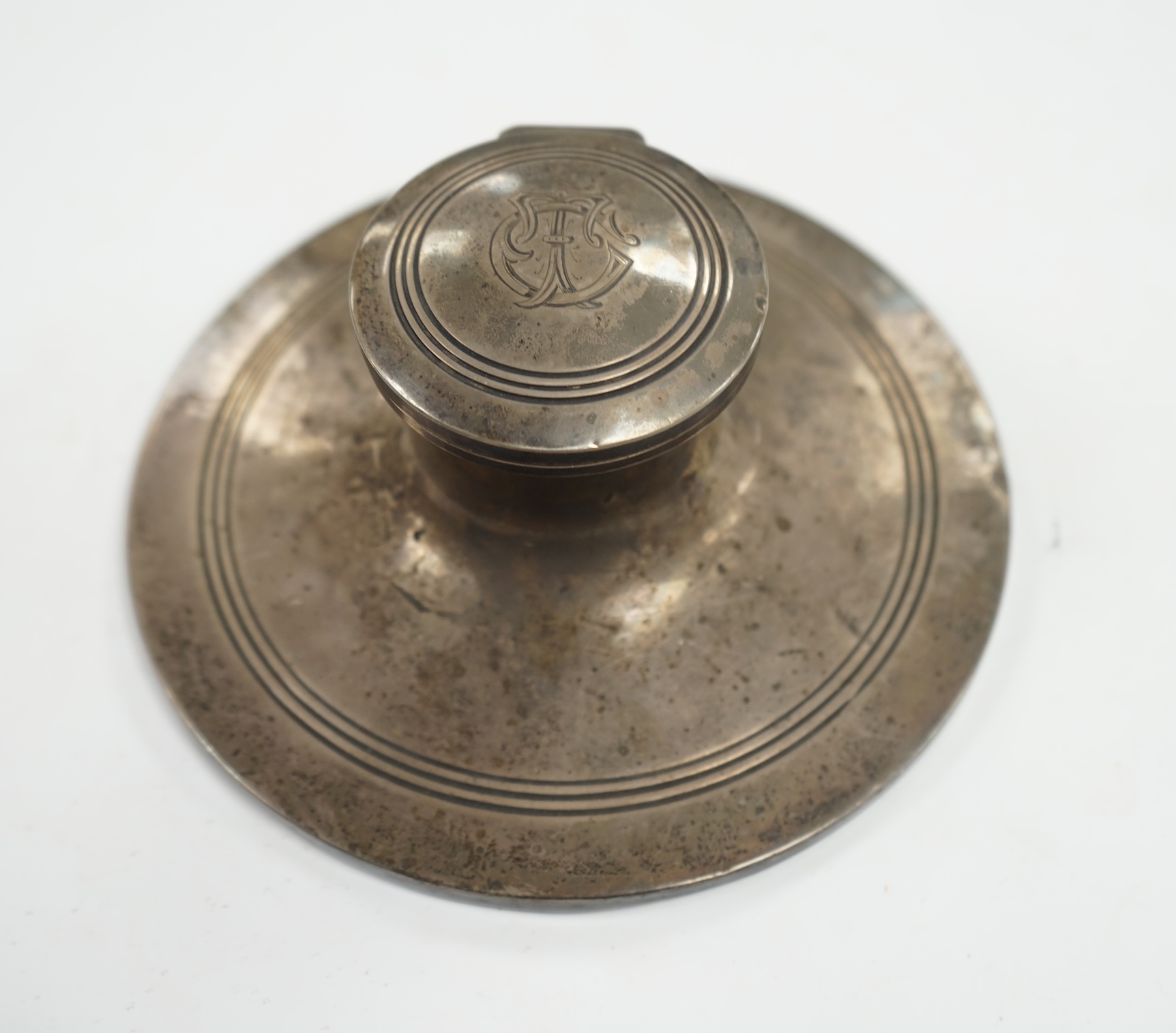 A George V silver mounted capstan inkwell, Birmingham, 1910, base diameter 15.2cm. Condition - poor to fair